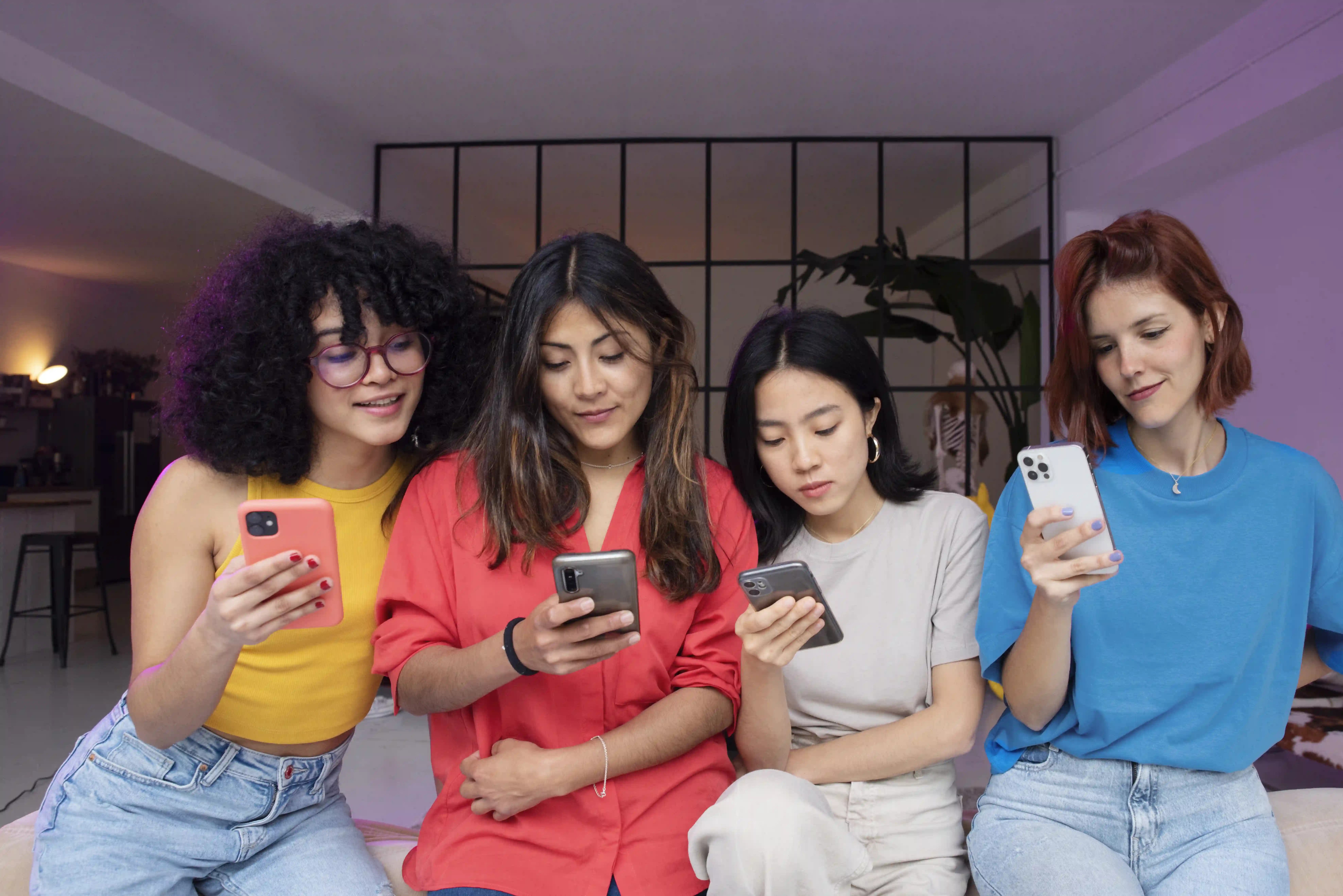 medium-shot-women-sitting-with-smartphones